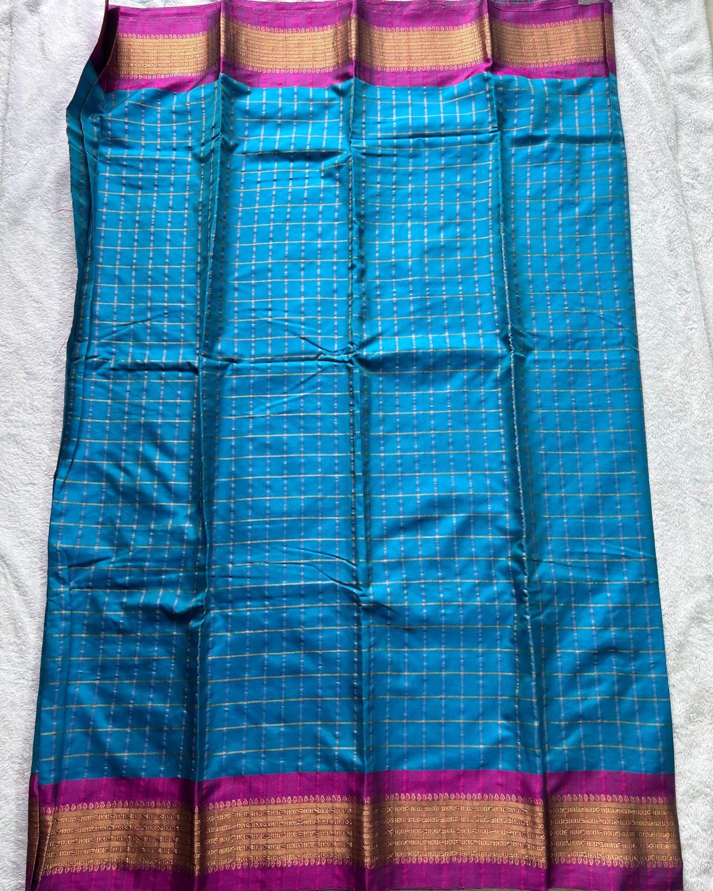Teal green with checks pattern semi silk saree