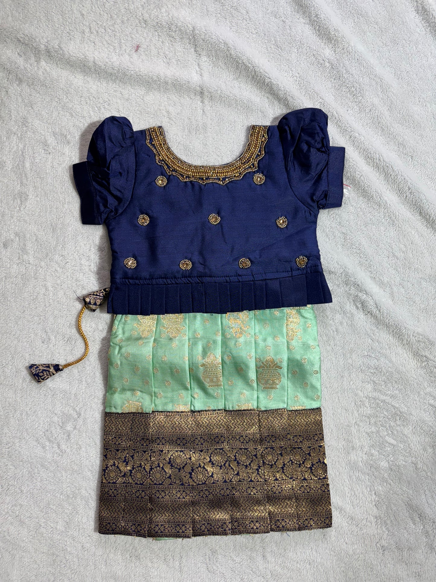 Navy blue blouse with handmade are work all over and pista green lehenga pattu pavadai