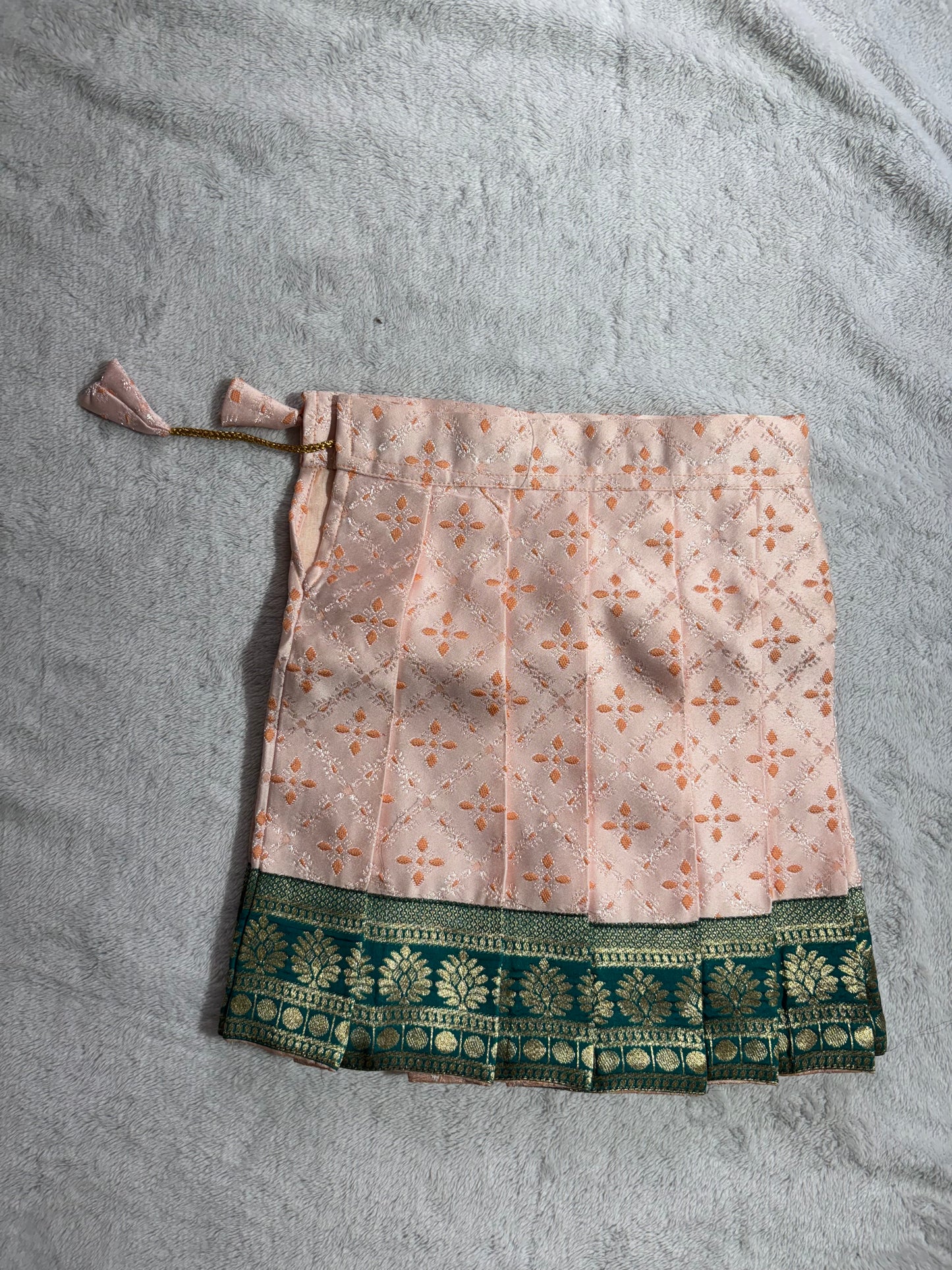 Dark green blouse with light peach lehenga pattu pavadai