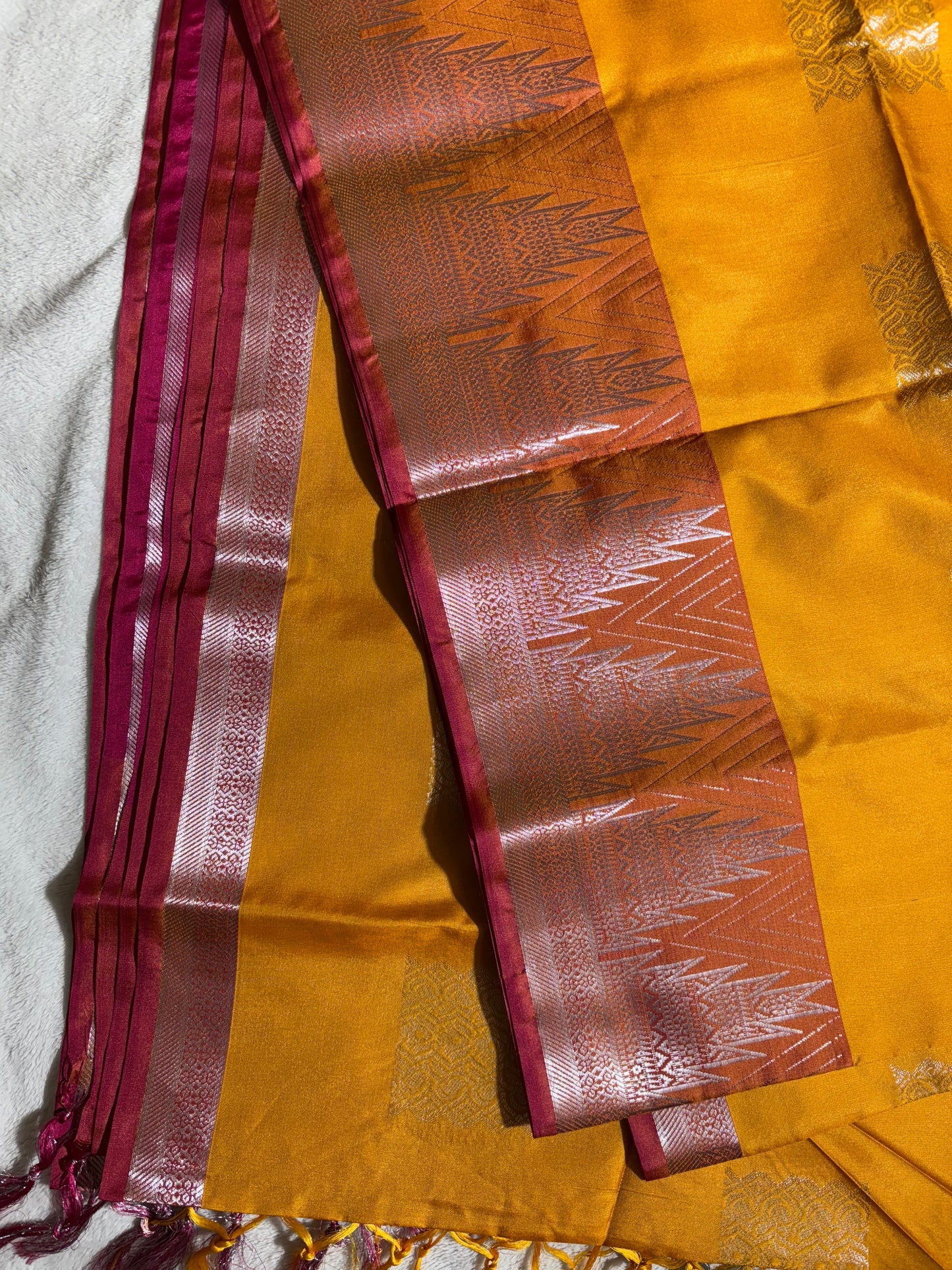 Mustard yellow with pink soft silk saree with temple border and tassels
