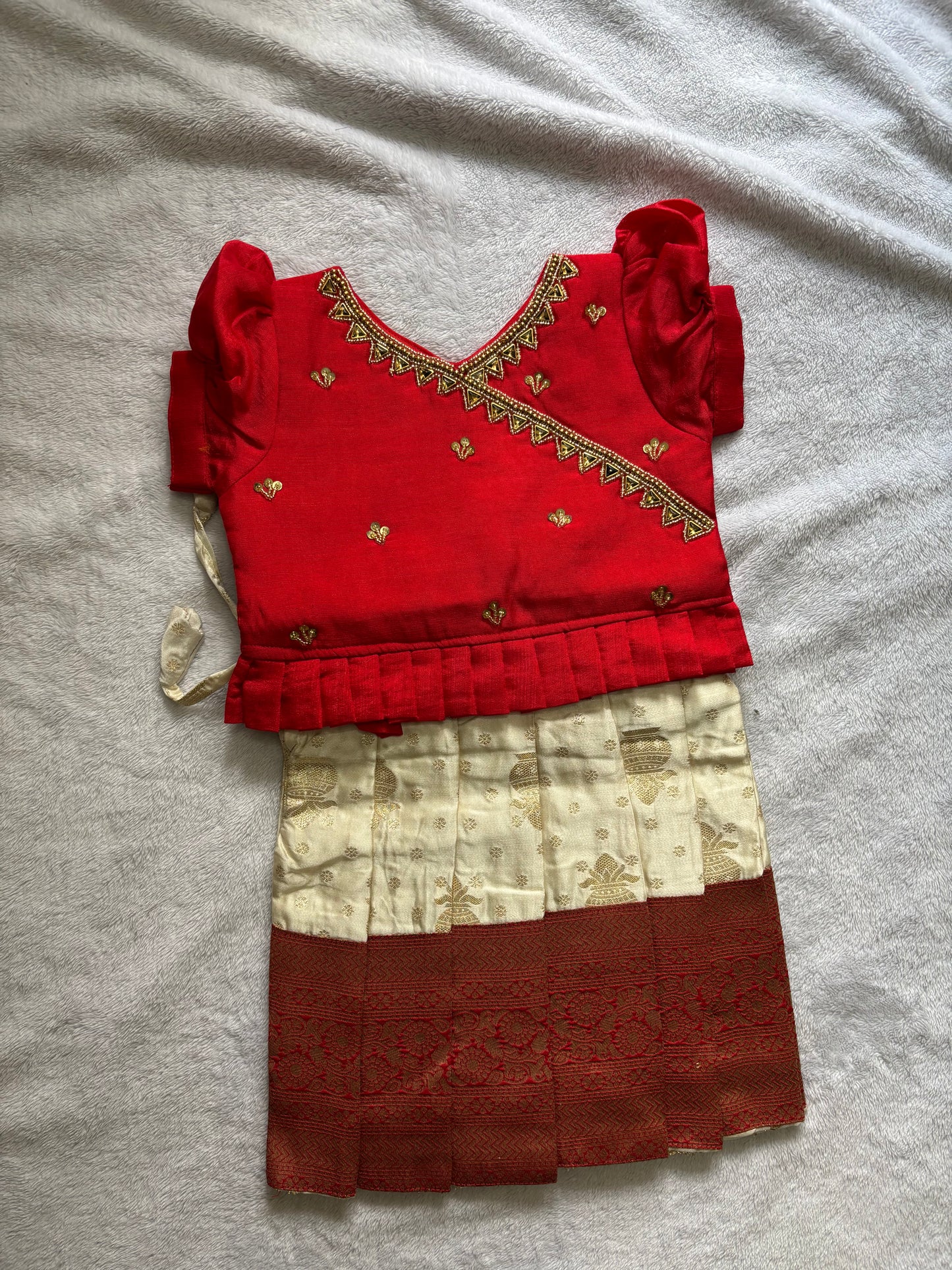 Red and half white pattu pavadai with handmade Ari work all over the jacquard blouse
