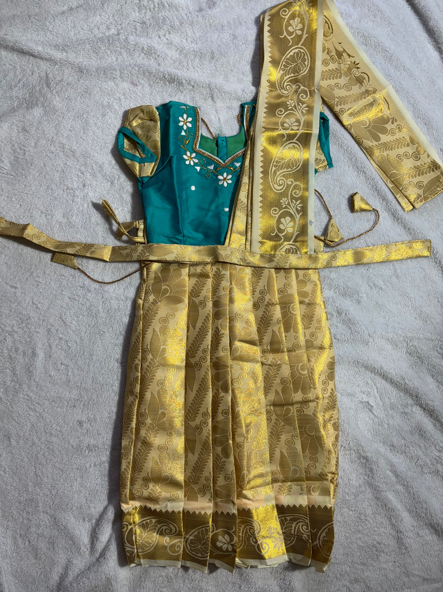 Rama green with a half white pattu pavadai with pleated waist belt