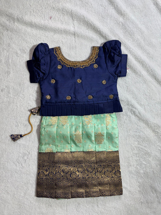 Navy blue blouse with handmade are work all over and pista green lehenga pattu pavadai