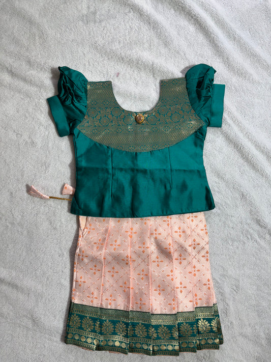 Dark green blouse with light peach lehenga pattu pavadai