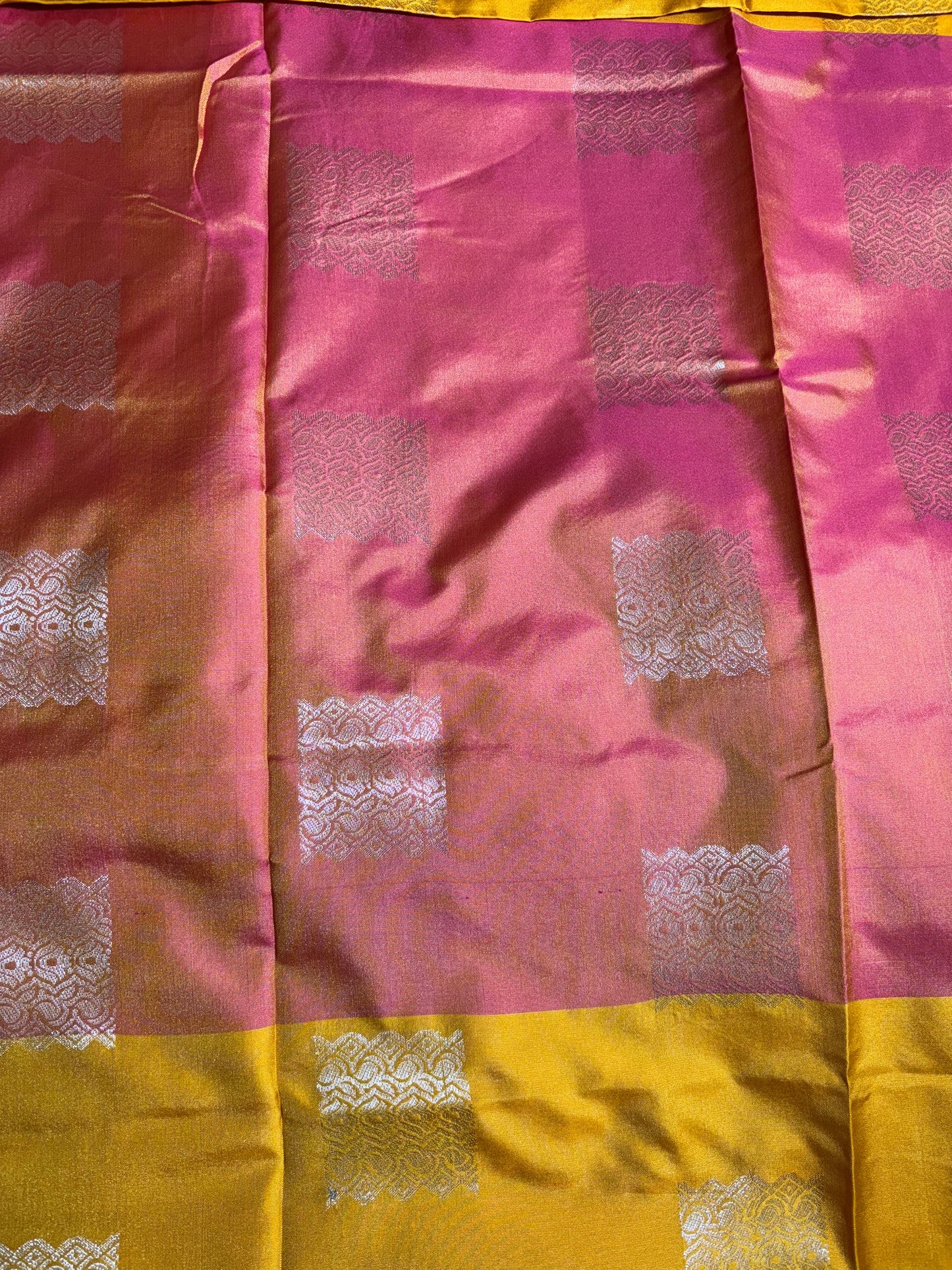 Mustard yellow with pink soft silk saree with temple border and tassels