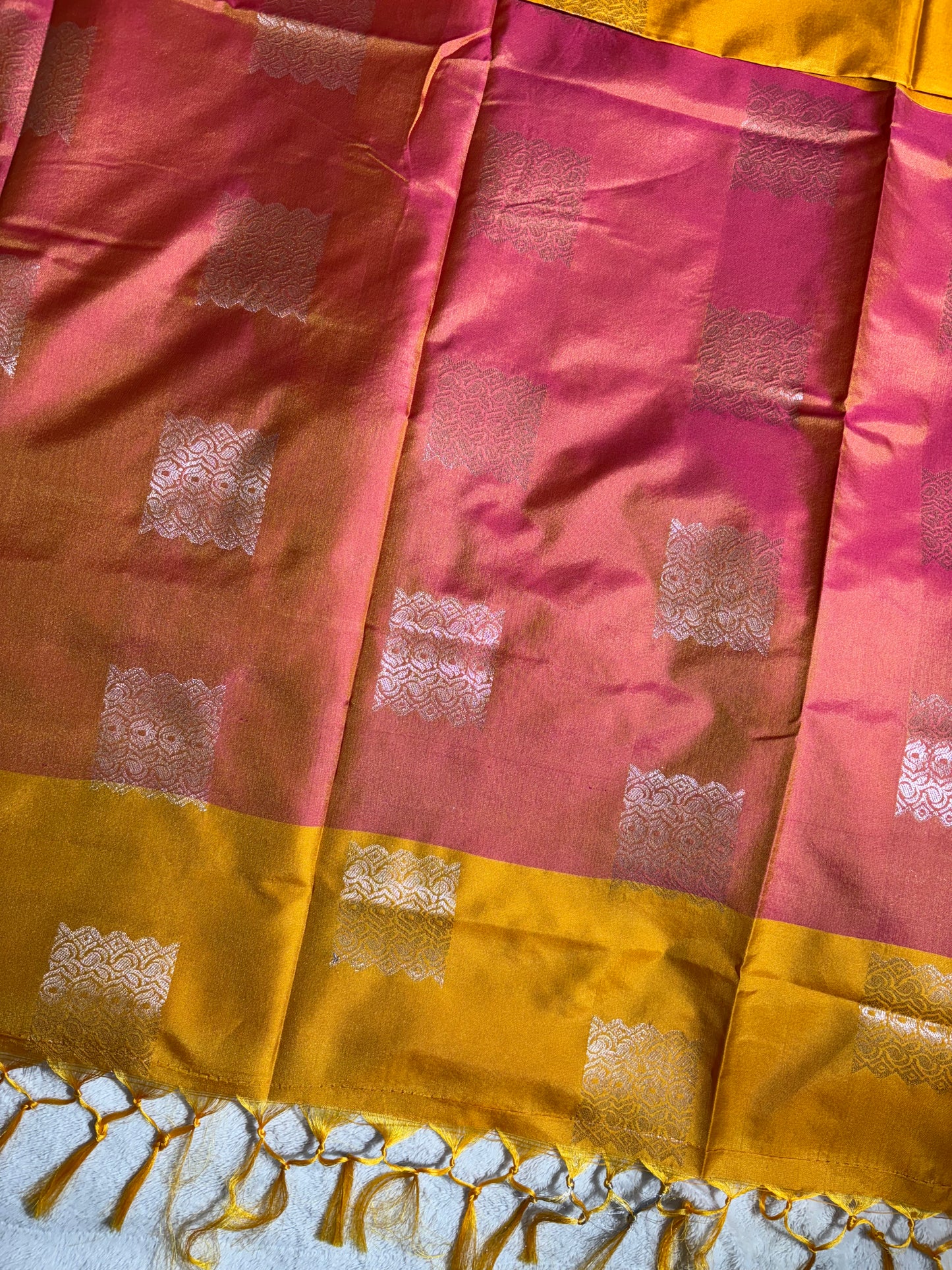 Mustard yellow with pink soft silk saree with temple border and tassels