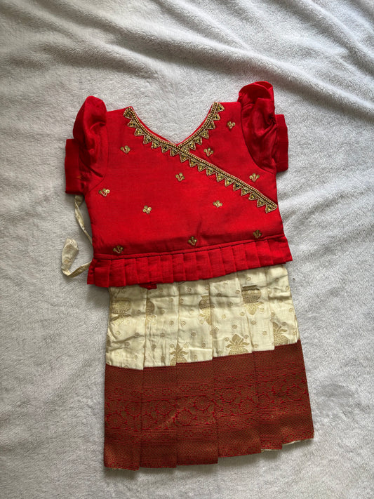 Red and half white pattu pavadai with handmade Ari work all over the jacquard blouse